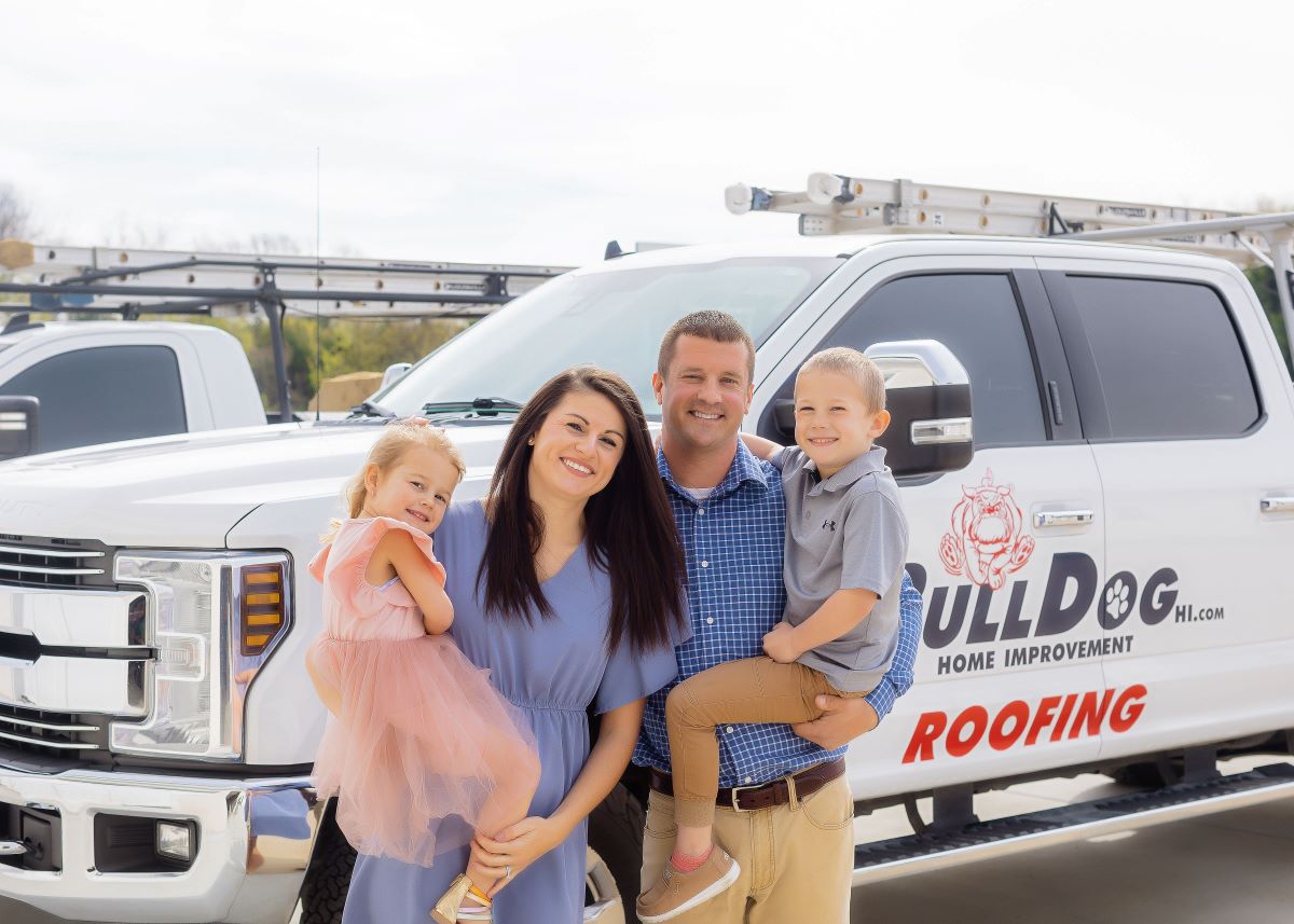 Image of owner Chris and his family in font of company truck